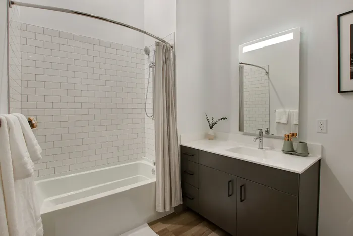 Serene bathrooms with quartz countertops and edge-lit mirrors at modera berkeley heights apartments in new jersey