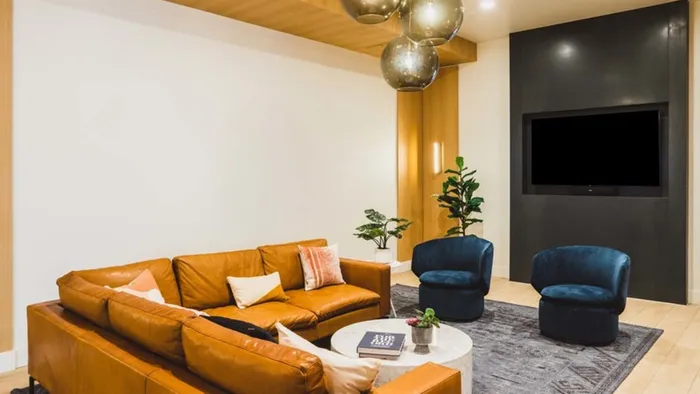 HDTV beside plush couches and HDTV at Modera Broadway apartments.