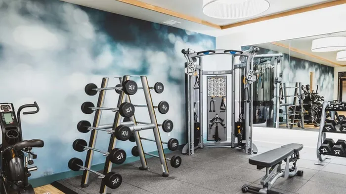Free weights, weight bench, weight stations and spin bikes in the fitness studio at Modera Broadway apartments.