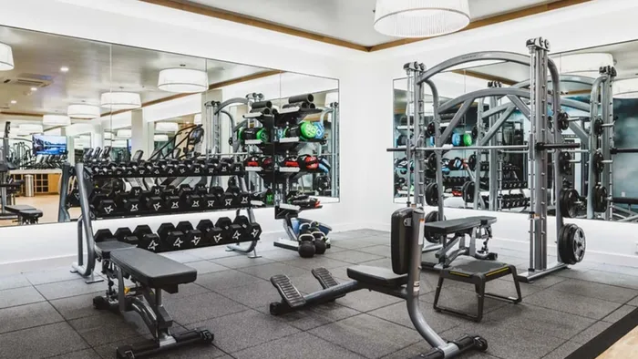 Fitness studio with mirrors offers a various of weights including hand weights and kettlebells at Modera Broadway apartments.