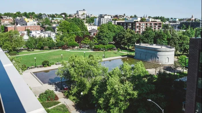Cal Anderson Park green space next to Modera Broadway with city beyond