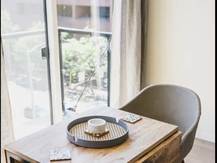 Breakfast table in front of balcony entrance at Modera Broadway