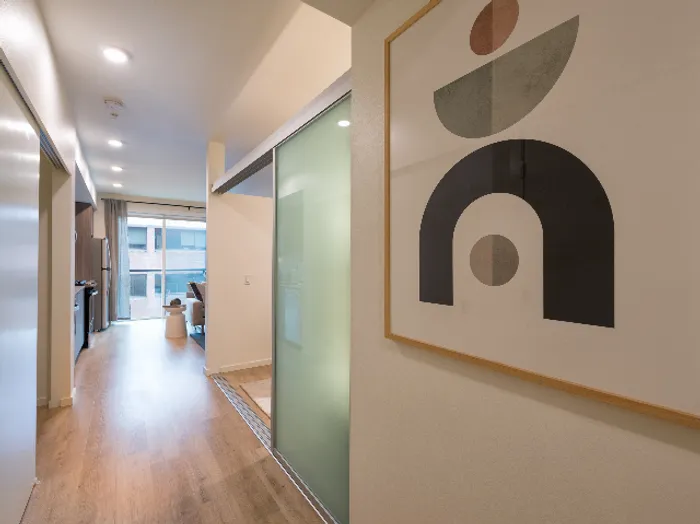 Hallway into Studio Apartment with Bedroom Privacy Door at Modera Broadway, Seattle apartments.