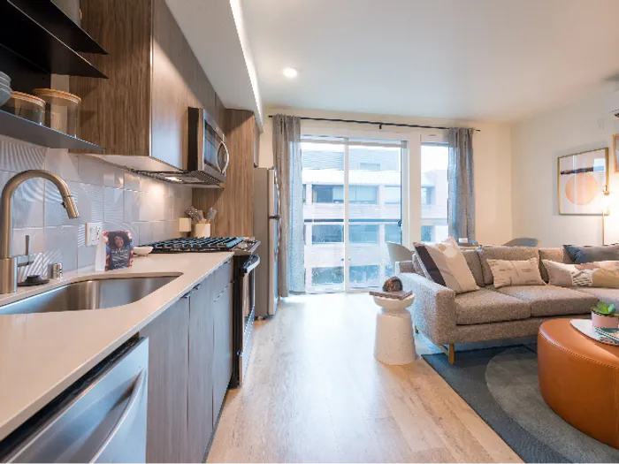 Modera Broadway kitchen featuring large windows, modern cabinetry, and a galley-style kitchen in Seattle apartments.