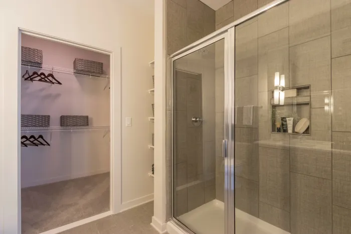 glass enclosed shower and closet at Modera Midtown apartment homes in atlanta georgia
