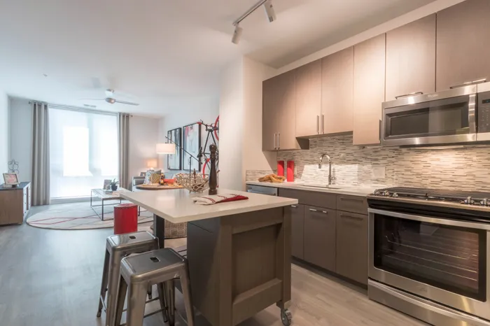 kitchen and dining area looking onto living room and windows at Modera Midtown apartment homes in atlanta georgia