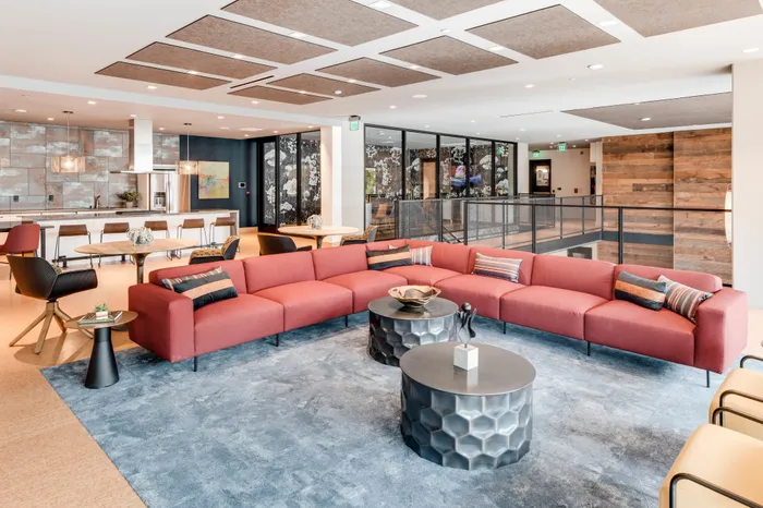 resident clubhouse space with ample seating and demonstration kitchen at modera jack london square apartment homes for rent in oakland california