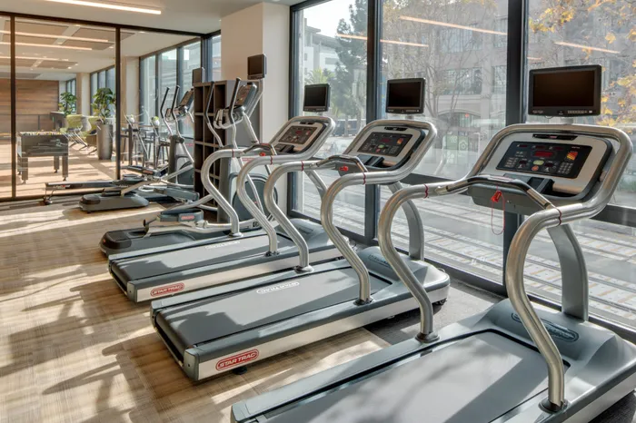 club quality gym with treadmill equipment at modera jack london square apartment homes for rent in oakland california