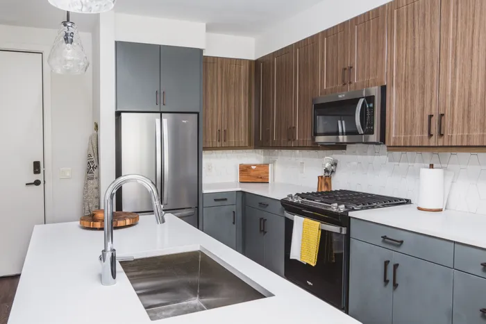kitchen with two-tone cabinetry and stainless steel appliances at modera decatur apartment homes for rent in georgia