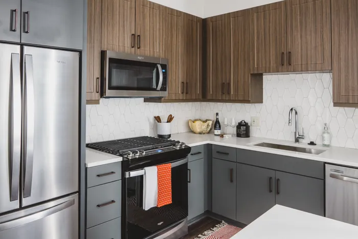 kitchen with two-tone cabinetry and stainless steel appliances at modera decatur apartment homes for rent in georgia