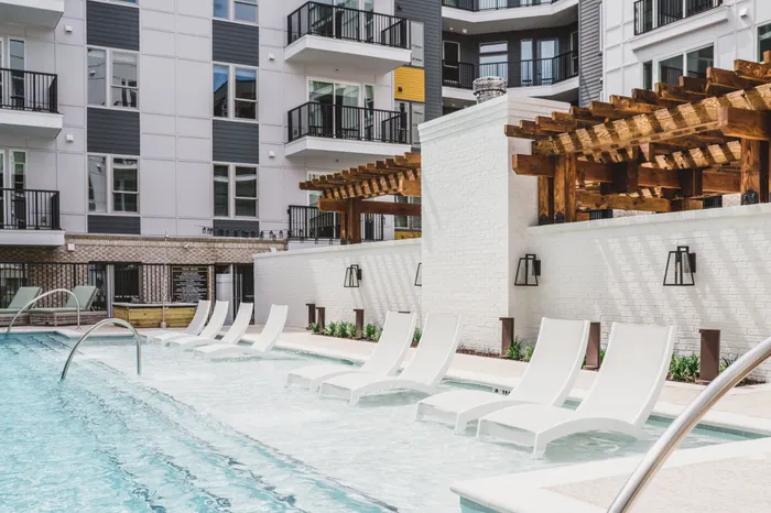 large swimming pool and sundeck and loungers at modera decatur apartment homes for rent in georgia