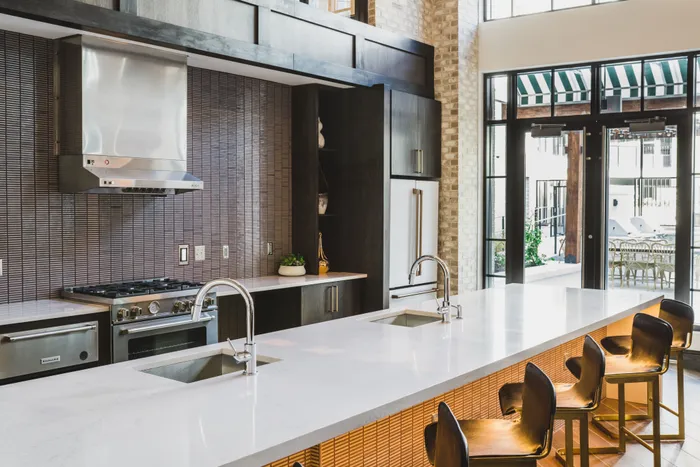 demonstration kitchen with stainless steel appliances at modera decatur apartment homes for rent in georgia