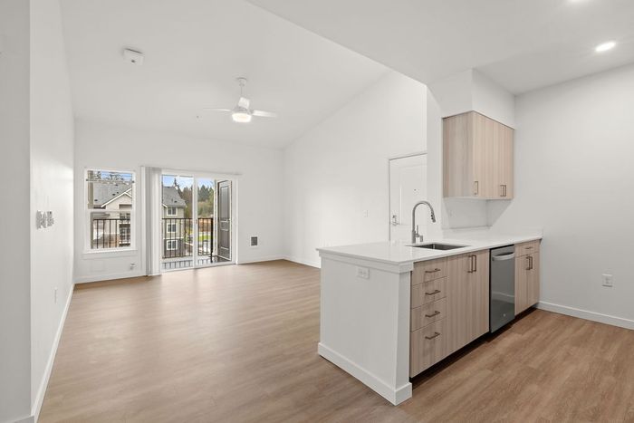 Stylish and modern kitchen with stainless steel appliances, quartz countertops, and ample cabinet space