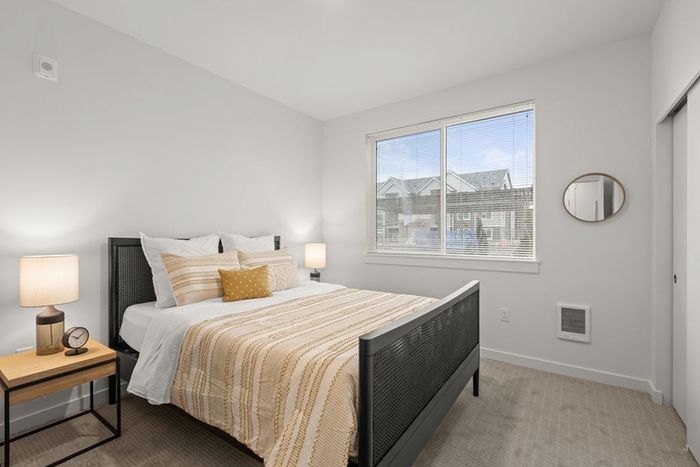 Spacious carpeted bedroom with oversized windows