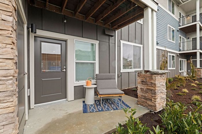 Inviting outdoor patio with comfortable seating, potted plants, and breathtaking woodland views