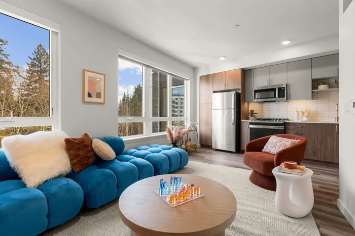 Model living room with comfortable furniture large windows and more