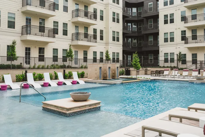 gorgeous resort-style pool with lounge seating at Modera Frisco Square apartments