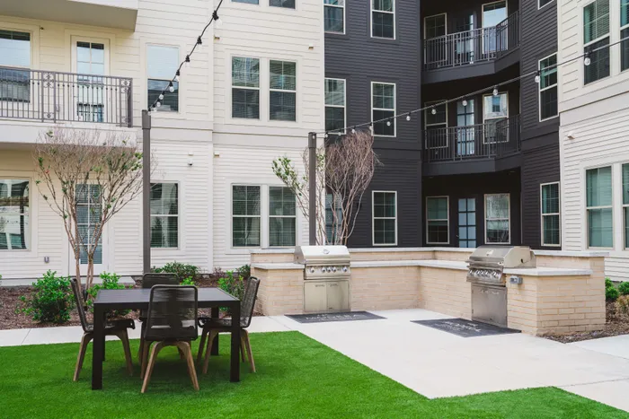 grilling area with outdoor dining at Modera Frisco Square apartments