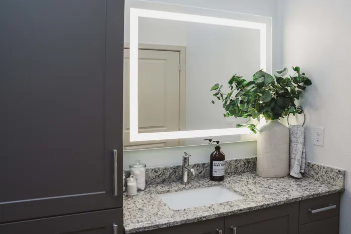 lighted vanity mirrors in a Modera Frisco Square apartment