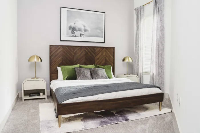 spacious primary bedrooms with cozy carpeting in a Modera Frisco Square apartment