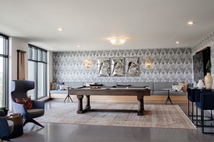 game room with pool table and adjacent seating modera art park apartment homes for rent in denver colorado