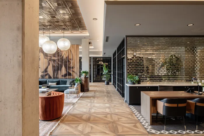 hallway separating lobby from leasing center area modera art park apartment homes for rent in denver colorado