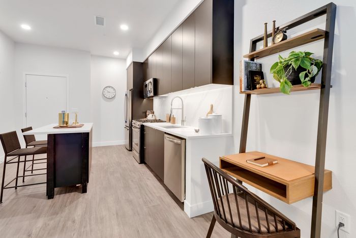 high end kitchen with wood plank style flooring modera art park apartment homes for rent in denver colorado