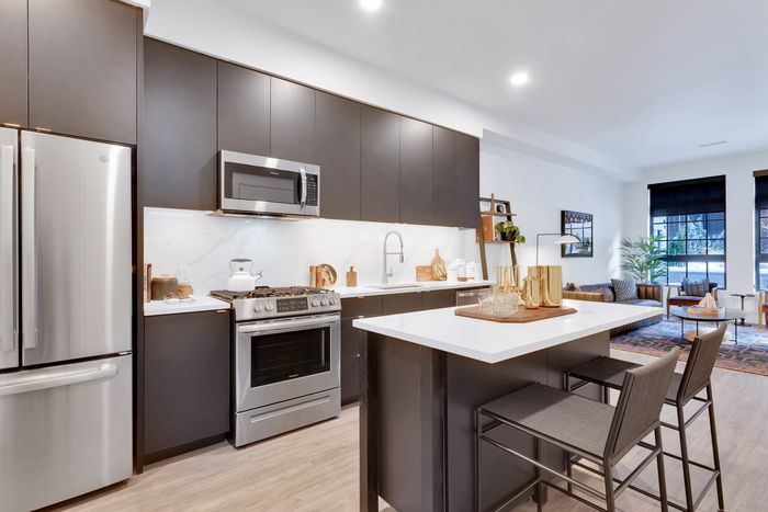 kitchen with dark cabinetry and soft close doors and drawers modera art park apartment homes for rent in denver colorado