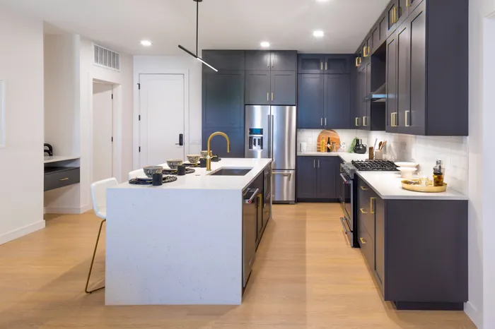 kitchen with island and stainless steel appliances modera cherry creek apartment homes for rent in denver colorado