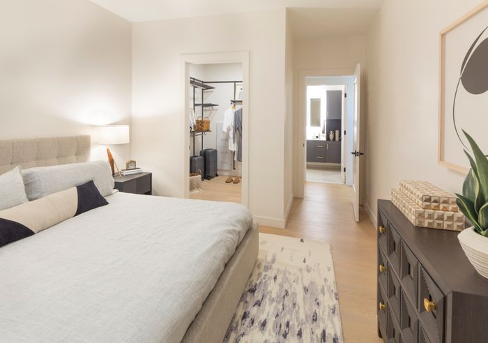 bedroom looking into closet and bathroom modera cherry creek apartment homes for rent in denver colorado