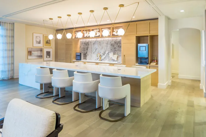 demonstration kitchen with coffee machine and bar seating modera cherry creek apartment homes for rent in denver colorado
