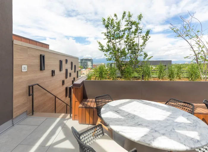 outdoor dining space with lush landscaping modera cherry creek apartment homes for rent in denver colorado