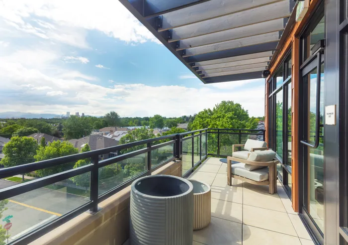 balcony with green views and seating modera cherry creek apartment homes for rent in denver colorado
