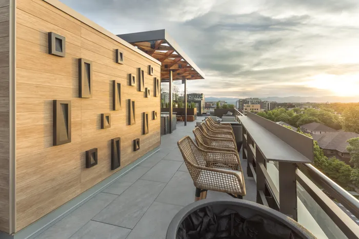 decorated wall next to outdoor dining and work from home space on roofotp modera cherry creek apartment homes for rent in denver colorado