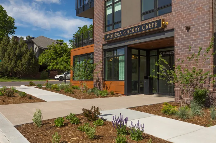 entrance with sign near sidewalk modera cherry creek apartment homes for rent in denver colorado