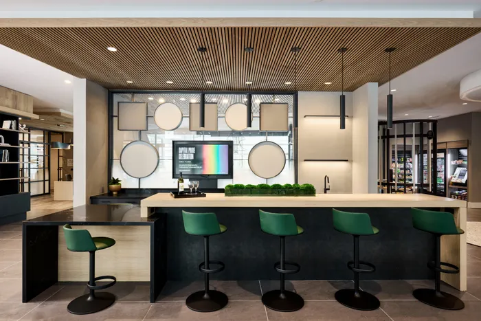 demonstration kitchen with seating and tv at modera clarendon apartment homes for rent in arlington va