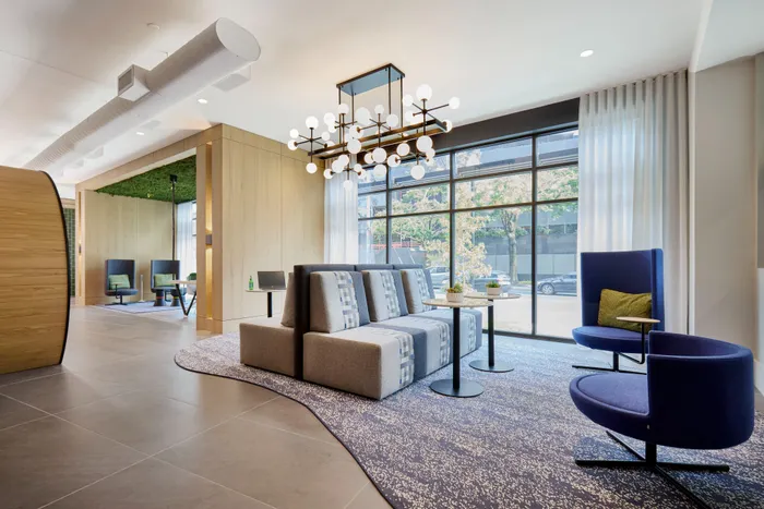 cowrking space with bench seating and small tables at modera clarendon apartment homes for rent in arlington va