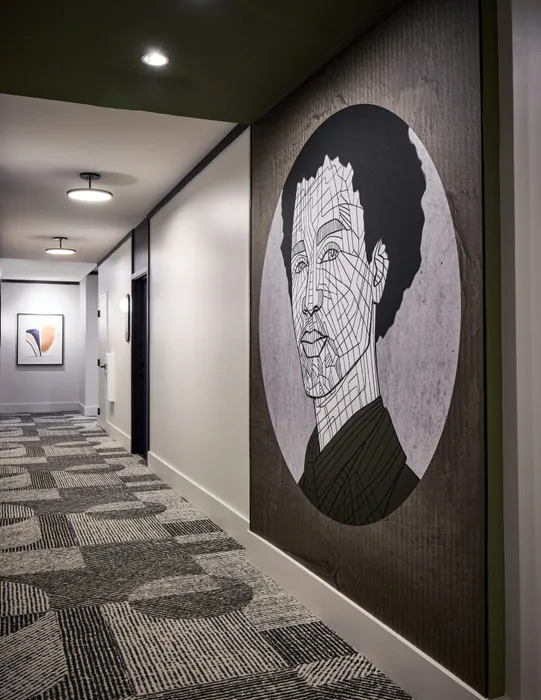 modern artwork hanging on hallway wall at modera clarendon apartment homes for rent in arlington va