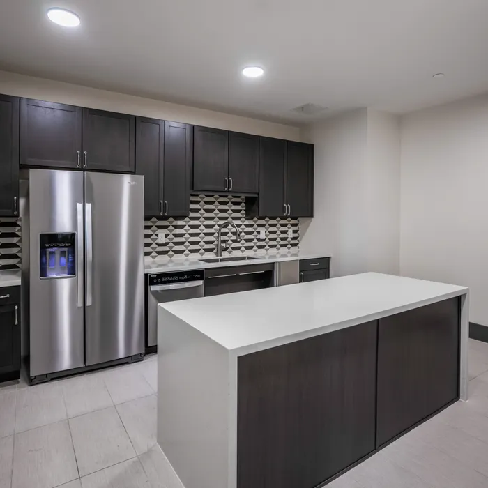 catering demonstration kitchen with island at modera six pines apartment homes for rent in shenandoah texas