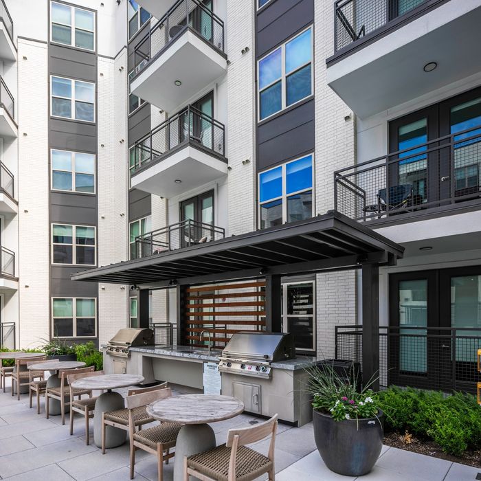 covered grills with outdoor dining space at modera six pines apartment homes for rent in texas
