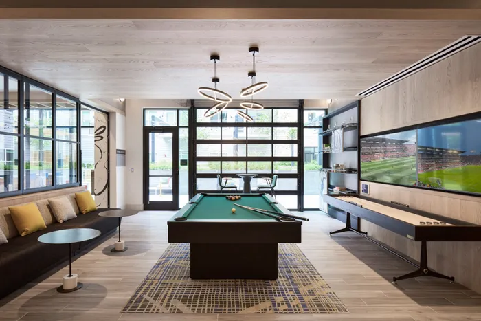 Game room with billiards, shuffleboard, 2 televisions, and comfortable sesating