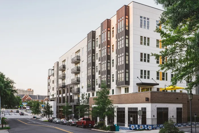 Exterior of Modera Decatur - gray and white building with patios and brick accents