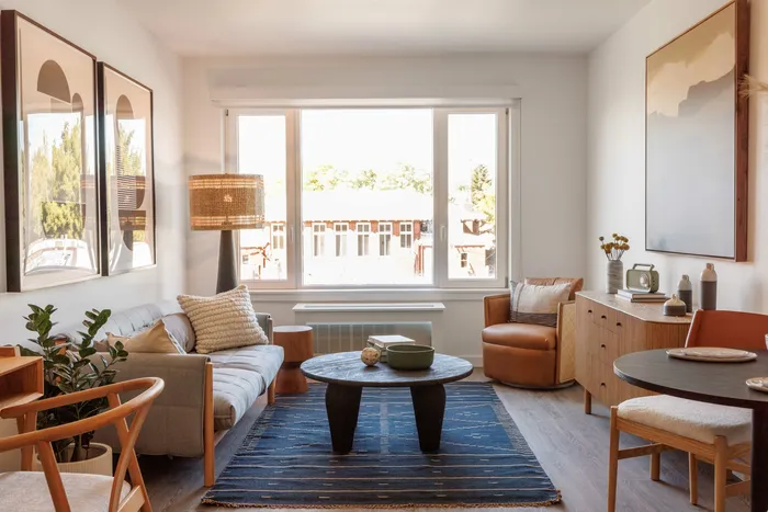 large living room with oversized windows and wood-style flooring