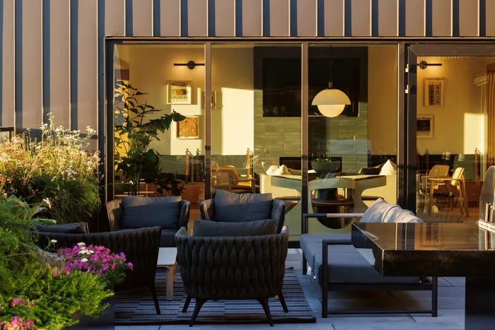 another view of rooftop deck with comfortable seating at dusk
