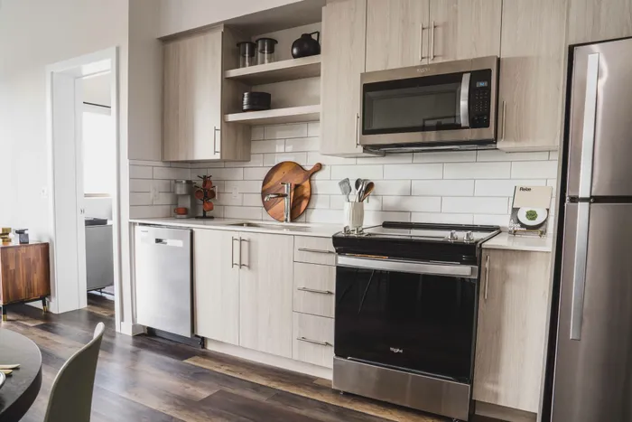Modera Coral Springs | Kitchen with stainless appliances, white cabinets and chef's island