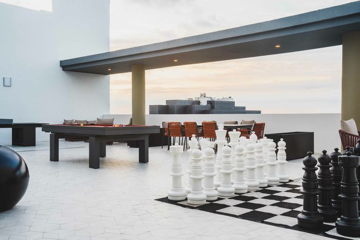 rooftop lounge with city views and giant chess