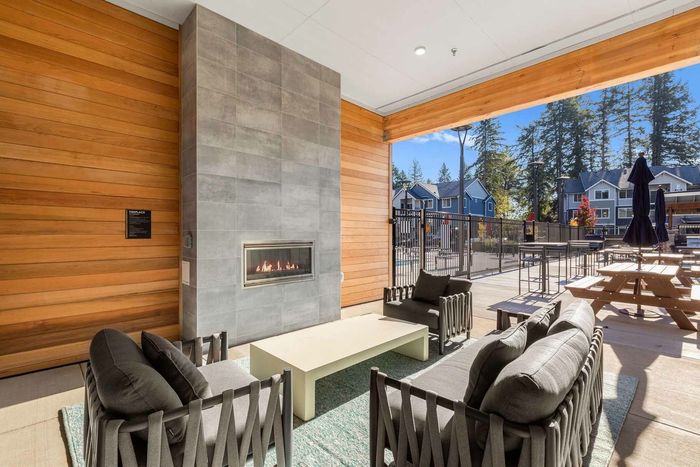 Outdoor fireplace and lounge seating in the community courtyard