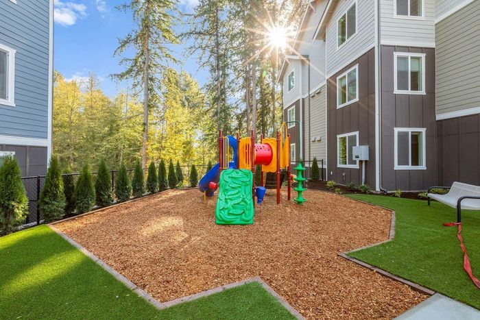 outdoor play area with turf and seating areas