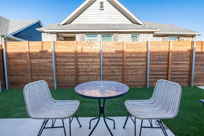 private fenced in backyard with seating at amavi celina single family homes for rent in texas