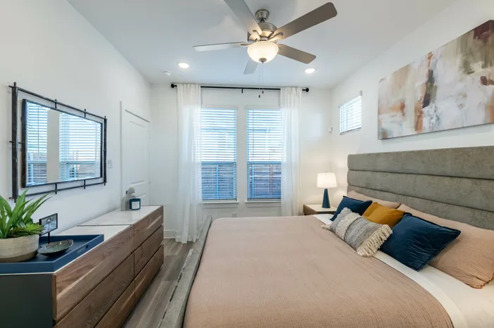 bedroom with bed looking towards large window at amavi celina single family homes for rent in texas